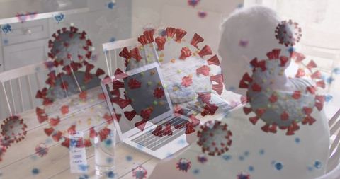 Senior man working from home with laptop and covid-19 overlay