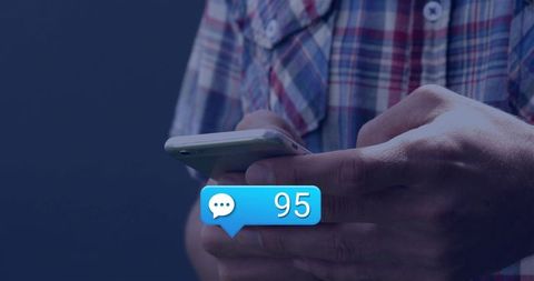 Hands holding smartphone with 95 message notification bubble, plaid shirt, social media messaging co