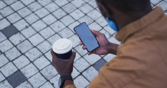 Man Checking Smartphone Outdoors with Coffee Cup - Download Free Stock Images Pikwizard.com