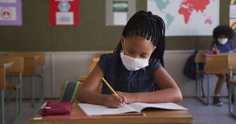 Young African American Girl Wearing Facemask Learning at School - Download Free Stock Images Pikwizard.com