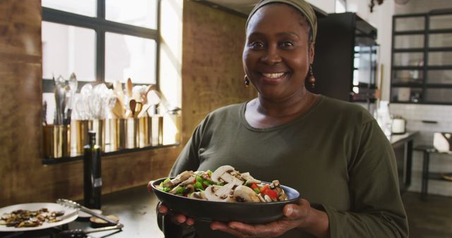 Smiling Woman Holding Fresh Salad in Modern Kitchen - Download Free Stock Images Pikwizard.com