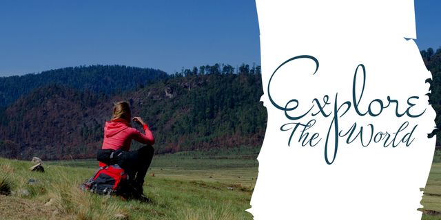 The template features a female traveler sitting on a grassy field, taking a photograph of a distant mountain range under clear skies. The graphic text 'Explore The World' emphasizes the spirit of adventure and wanderlust. Perfect for travel blogs, outdoor adventure promotional materials, and social media posts celebrating nature and exploration.
