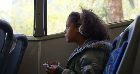 Girl listening to music on bus journey