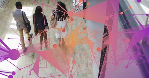 Young professionals walking modern office with vibrant digital network overlay for tech