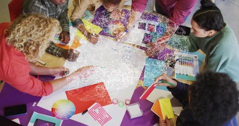 Creative Team Brainstorming with Color Swatches in Design Studio