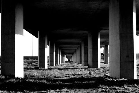 Symmetrical concrete overpass with strong depth from columns