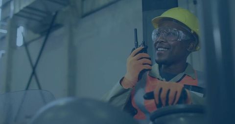 Warehouse Worker Operating Forklift with Safety Gear and Two-Way Radio