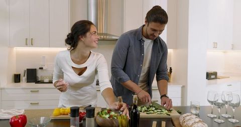 Couple Cooking Together in Modern Kitchen Creating Fresh Salad
