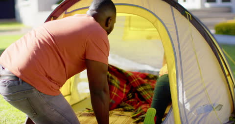 Father and Son Setting Up Tent in Garden Adventure