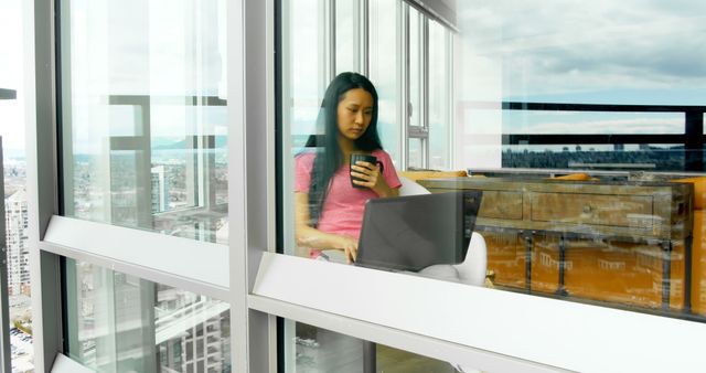 Woman Remote Working from Modern Apartment with City View - Download Free Stock Images Pikwizard.com