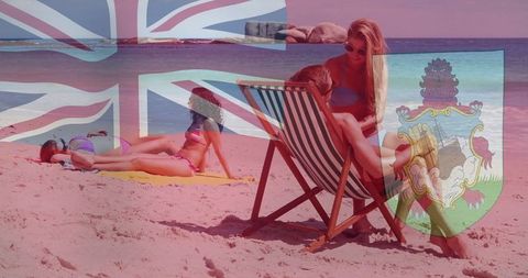 Couple relaxing on beach with union jack overlay