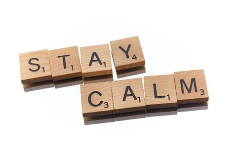 Stay calm message spelled in wooden scrabble tiles