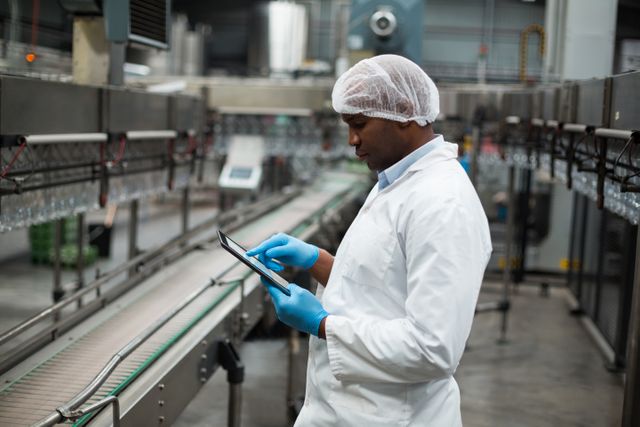 Factory engineer using digital tablet in the factory	Factory engineer using digital tablet in drinks production plant