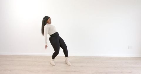 Woman Dancing Energetically in Minimalist Room
