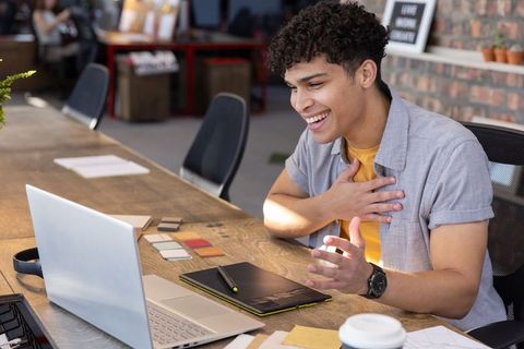 Creative Designer Engaging Online While Working in Shared Workspace