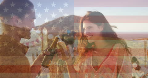 Patriotic Celebration with Friends at Sunset Overlaid with US Flag