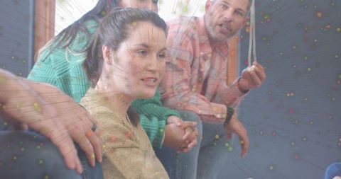 Mid-adult woman leading collaborative group discussion in casual circle workshop by window