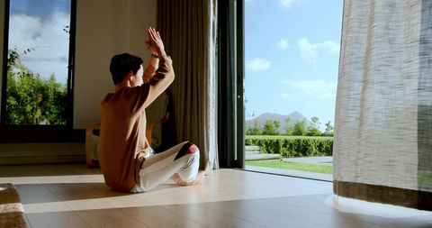 Relaxed Morning Yoga Near Scenic Sliding Glass Door View