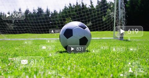 Striker kicking soccer ball toward goal with goalkeeper diving and social media overlays