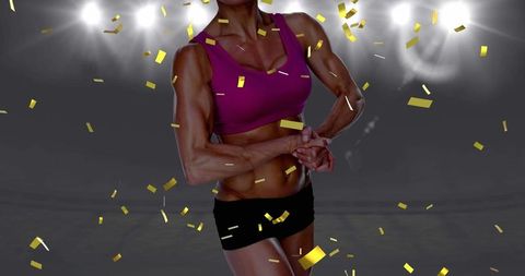 Golden Confetti Over Fit Female Athlete Flexing in Stadium