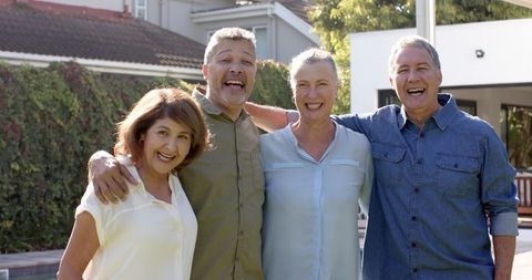 Diverse Senior Friends Smiling Outdoors on a Sunny Day
