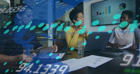 Businesswomen Analyzing Digital Data with Gadgets in Meeting Room
