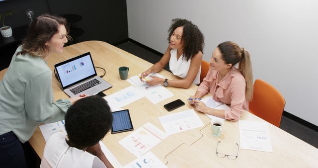 Women Collaborating in Business Meeting Around Office Table - Download Free Stock Images Pikwizard.com