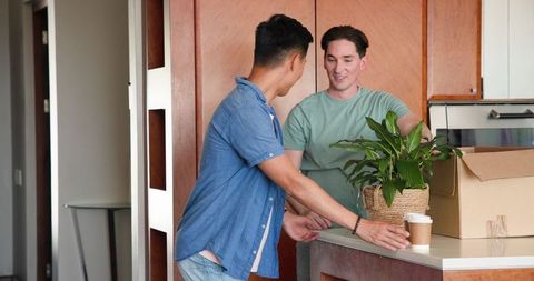 Diverse Couple Sharing Joyful Moments in Modern Kitchen