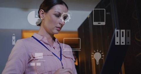 IT Technician Inspecting Server Rack Using Touchscreen Monitor in Dim Data Center