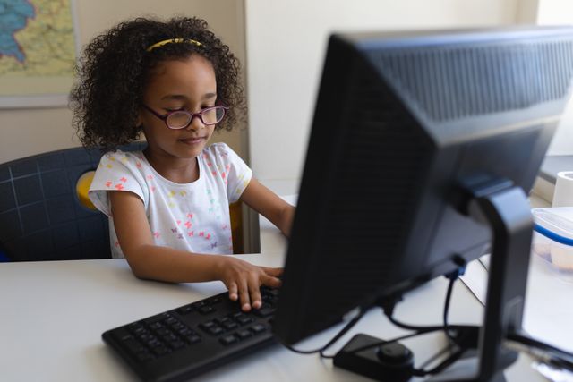 Young Black Schoolgirl Using Desktop Computer in Classroom - Download Free Stock Photos Pikwizard.com