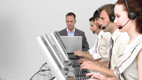 Professional Team Working in Business Call Center with Headsets