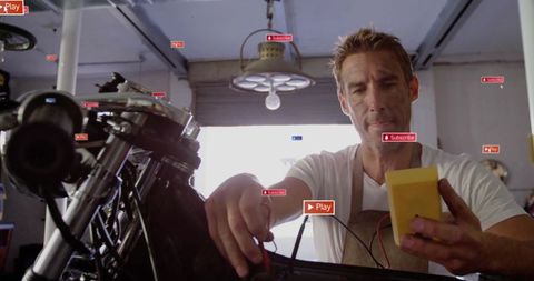 Mechanic testing motorcycle wiring with multimeter in workshop