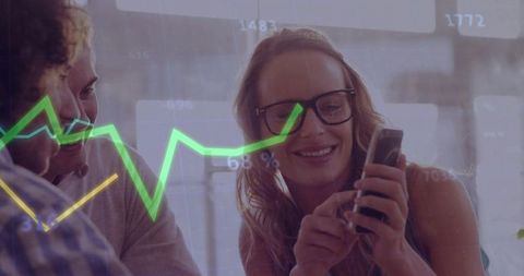 Team collaborating over mobile analytics with green growth chart overlay in modern office