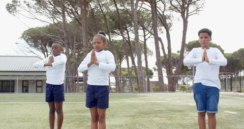 Youthful unity: children practicing teamwork outdoors in sunny playground
