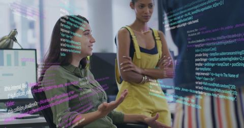 Diverse Women Engaging Financial Data in Modern Office Setting