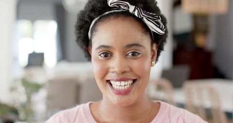 Smiling African American Woman Relaxing in Cozy Home Interior