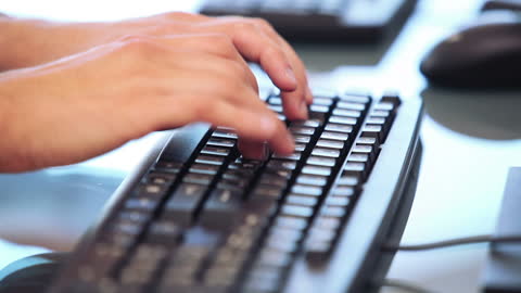 Hands Typing on Computer Keyboard for Office Work