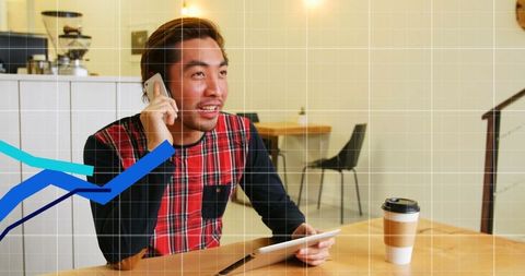 Man Talking on Smartphone with Digital Graph Overlay in Cafeteria
