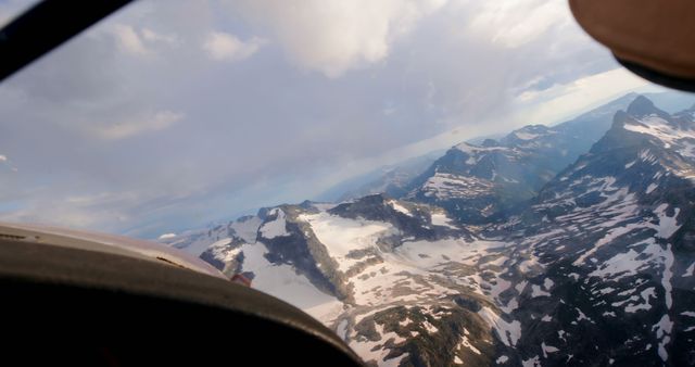 Aerial View of Snow-Capped Mountain Peaks on a Cloudy Day - Download Free Stock Images Pikwizard.com