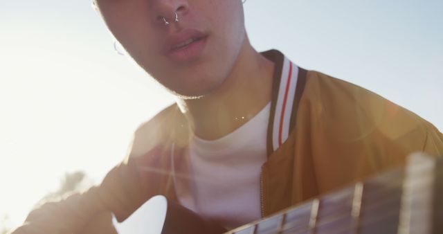 Close-up of Young Musician Playing Acoustic Guitar Outdoors - Download Free Stock Images Pikwizard.com