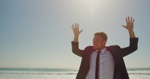 Joyful Businessman Dancing on Sunny Beach