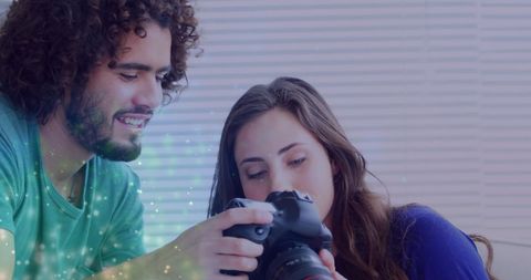 Creative photographer teaching female model with dslr camera