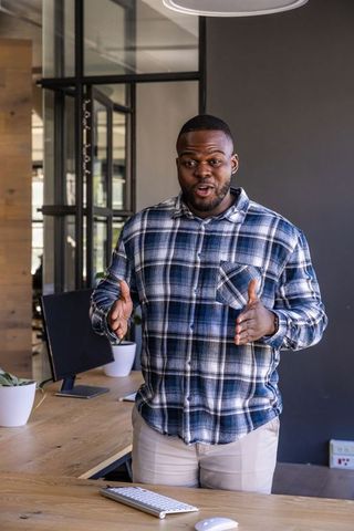 Professional Man Expressing Ideas in Modern Office