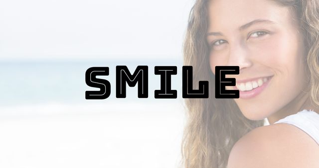 Digital composite image of smile text over happy biracial woman with long hair at beach. Mood and feeling, emotion, happiness, wellness, healthy lifestyle.
