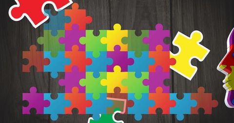 Colorful Autism Awareness Puzzle Pieces on Dark Wood Background - Download Free Stock Images Pikwizard.com
