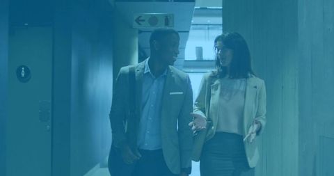 Professional Business Colleagues Walking in Office Corridor