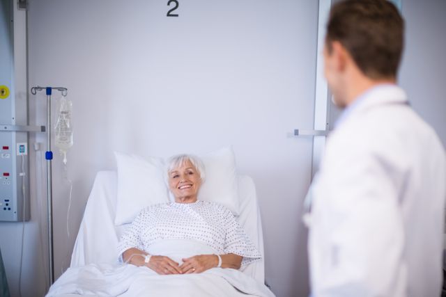 Doctors talking to a senior patient in hospital room