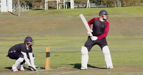 Adult Batsman in Action on Outdoor Cricket Field