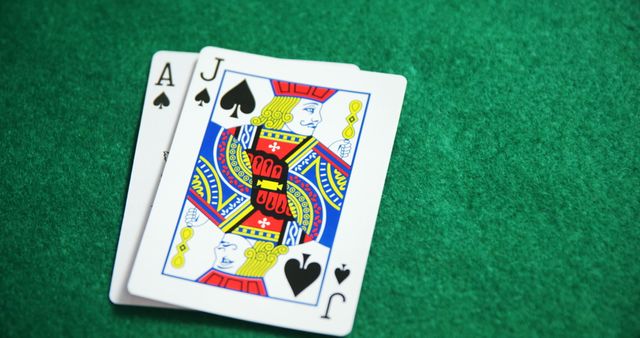 Displays fresh Ace and Jack of Spades on green felt, representing a classic Blackjack winning hand. Use for gambling promotions, casino marketing, or game strategy illustrations.