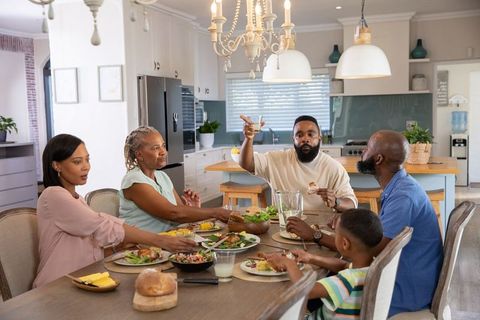 Family Gathering around Dining Table Enjoying Meal